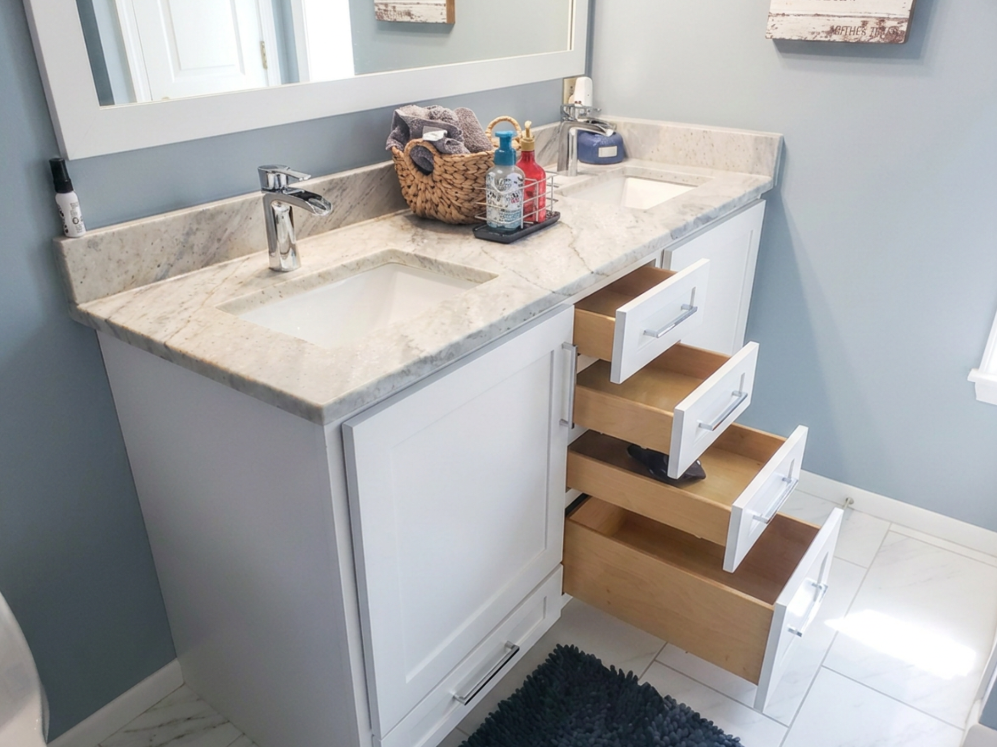 White bathroom vanity with granite countertop